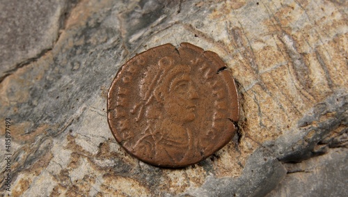 Old Roman coin on stone Theodosius the Great background		