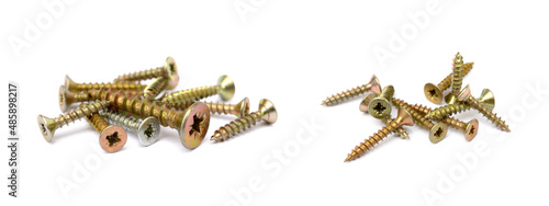 Scattered wood screws isolated on white background photo