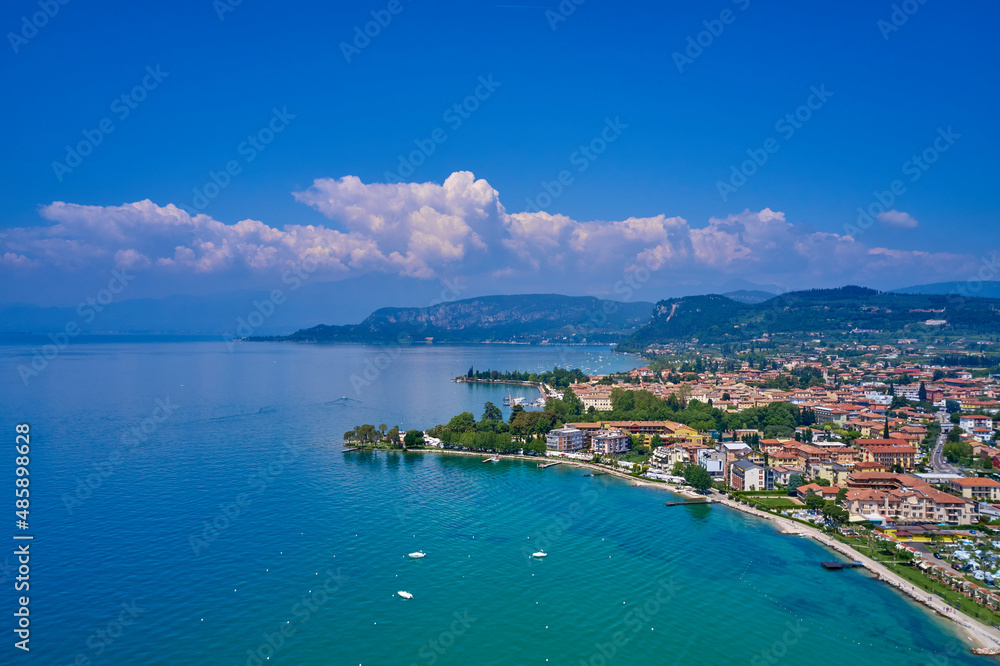 View by Drone. Docked yachts parking in Port. Aerial photography. Beautiful coastline. In the city of Bardolino, Lake Garda is the north of Italy.