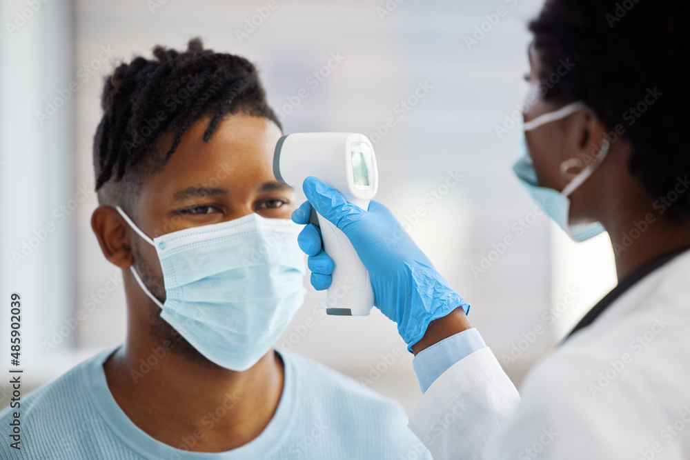 Your temperature seems a bit high. Shot of a female doctor taking the temperature of her patient. Your temperature seems a bit high. Shot of a female doctor taking the temperature of her patient.