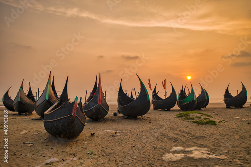 View of traditional fishing boats along the shoreline at sunset on the beach on St. Martin's Island, Teknaf, Chittagong, Bangladesh. photo