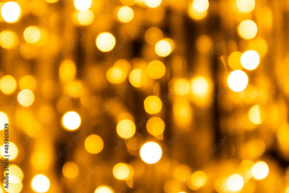 Yellow lights garland close-up on a tree. Photo in the bokeh style. Yellow lights garland close-up on a tree. Photo in the bokeh style.
