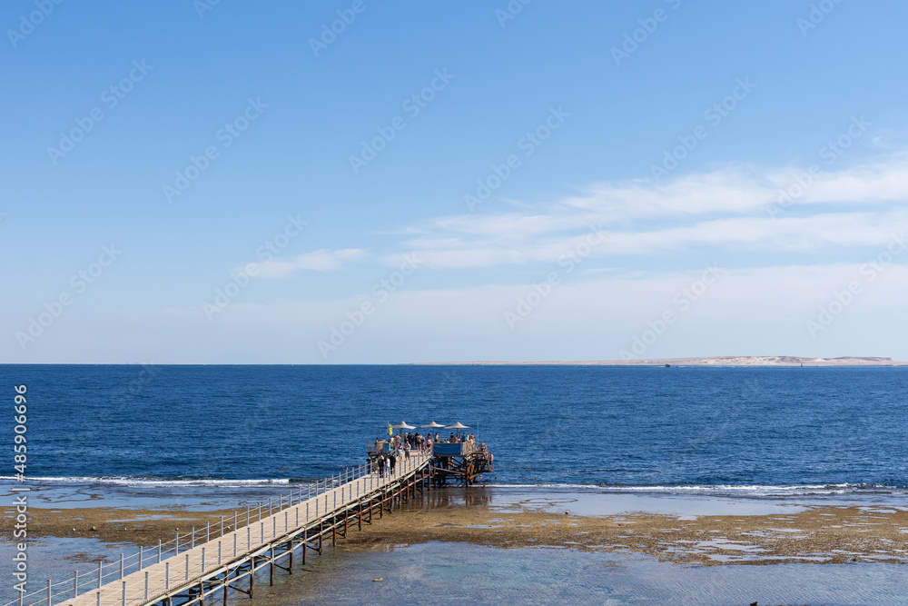 Dilapidated Pier in the Red Sea. Tiran Island on Backdrop. Dilapidated Pier in the Red Sea. Tiran Island on Backdrop.
