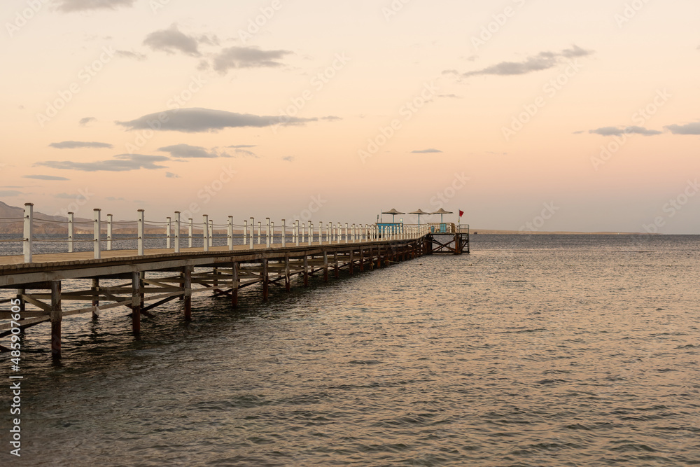 Golden sea sunset on the wooden pier.