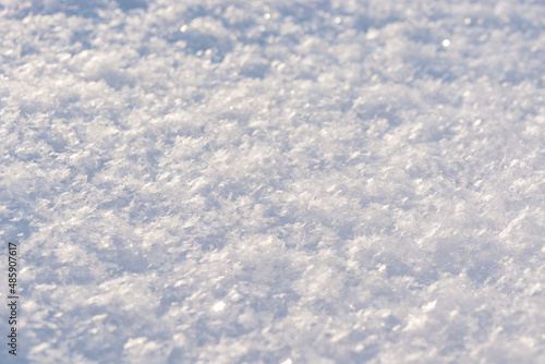 Fresh white shiny snow close up. Crystal snow macro photo. Snow background
