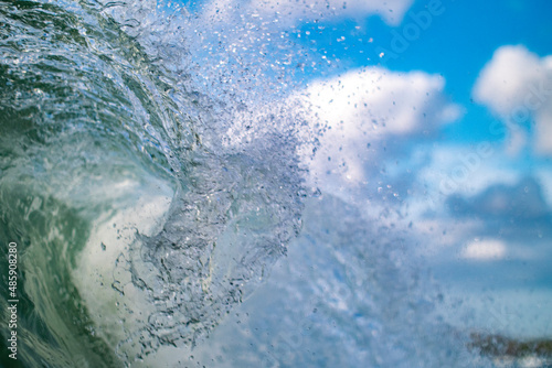 Crashing Wave detail with blue sky in background © bartsadowski