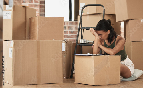 To some moving house is just another habit. Shot of a young woman having a stressful day during packing at home.