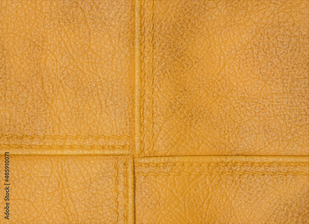 Fototapeta premium Yellow texture leather background. Stitch leather.