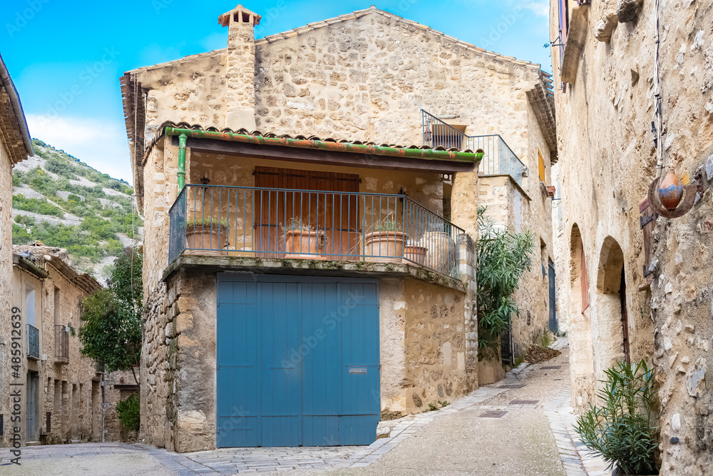Saint-Guilhem-le-Desert in France, view of the village, typical street and houses
