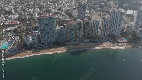 Beautiful view of the beach, aerial view of the beach, acapulco beach seen from above. Travel and vacation concept. Colorful sunset on the beach. Aerial video.