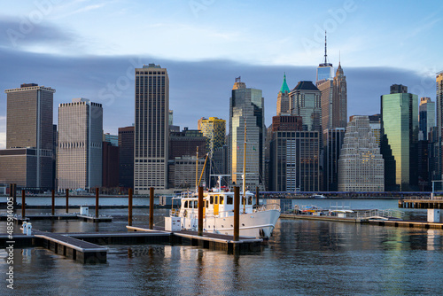 Financial district skyline of downtown New York City shot from pier over East River