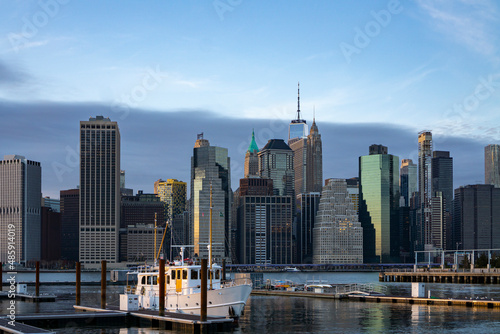 Financial district skyline of downtown New York City shot from pier over East River