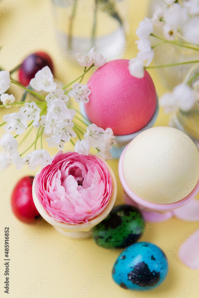Easter eggs, flowers on yellow background Easter eggs, flowers on yellow background