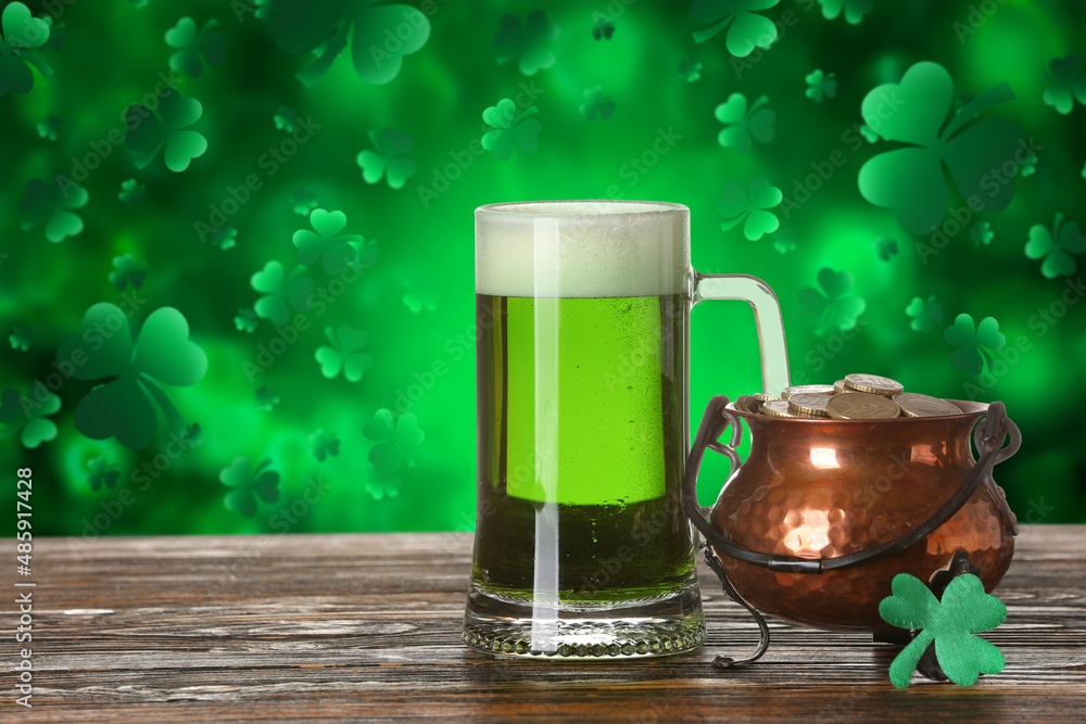 Glass of beer and pot with coins on table against green background. St.  Patrick's Day celebration Photos | Adobe Stock