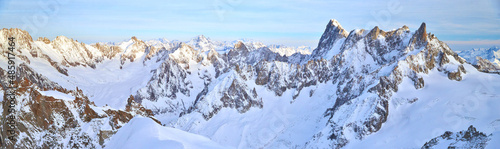 The mountain Aiguille du Midi 3842 meters in the Mont Blanc massif in the French Alps at sunset, panoramic image, peaks of mountains © Vladimir Drozdin