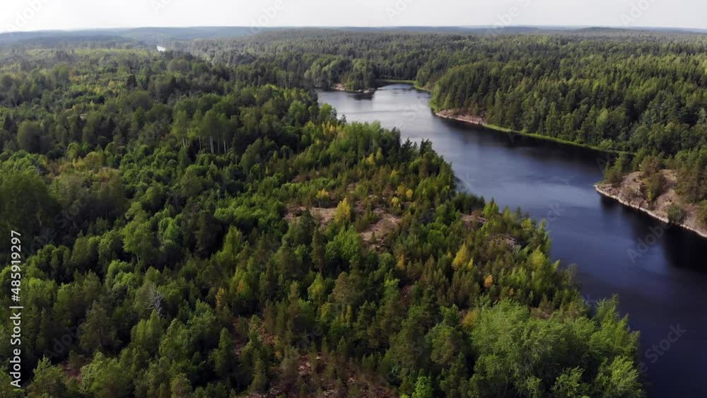 Wooded landscape at Ladoga Skerries from air, calm Murolahti bay waters seen down. Beautiful green and wild nature of Republic of Karelia, northwestern Russia area at summer time Wooded landscape at Ladoga Skerries from air, calm Murolahti bay waters seen down. Beautiful green and wild nature of Republic of Karelia, northwestern Russia area at summer time