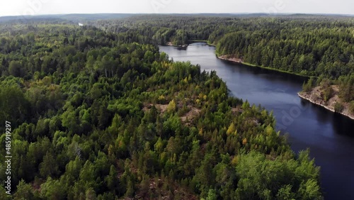 Wooded landscape at Ladoga Skerries from air, calm Murolahti bay waters seen down. Beautiful green and wild nature of Republic of Karelia, northwestern Russia area at summer time photo