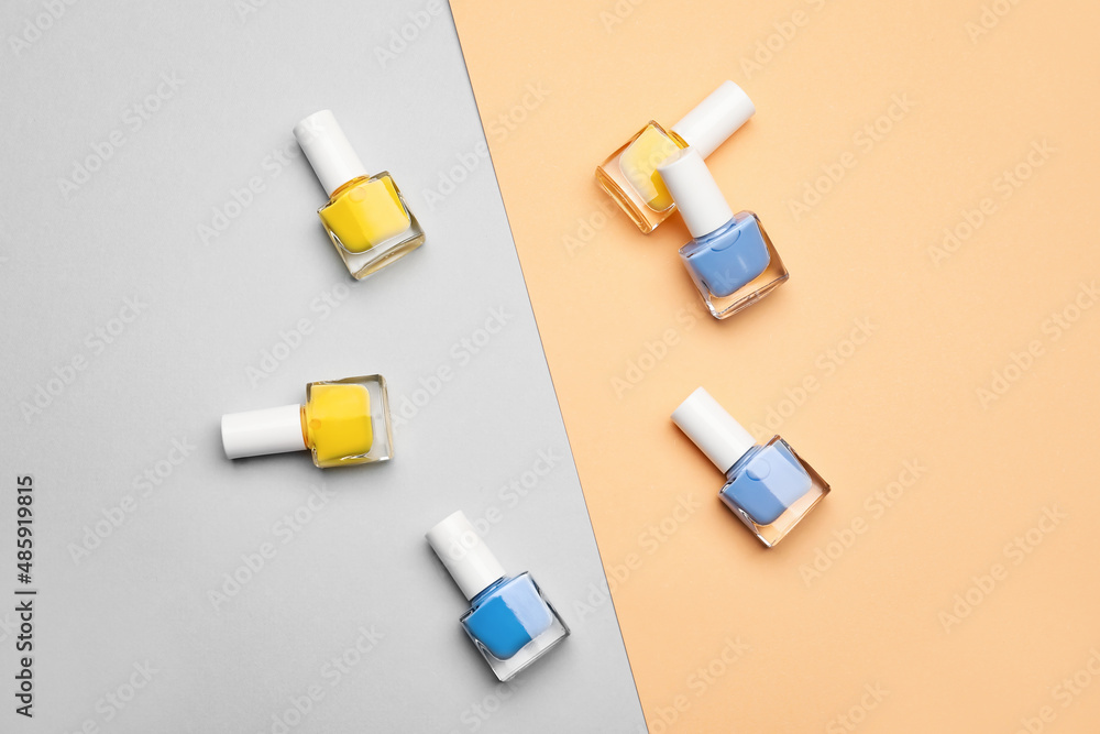 Frame made of nail polish bottles on color background Frame made of nail polish bottles on color background