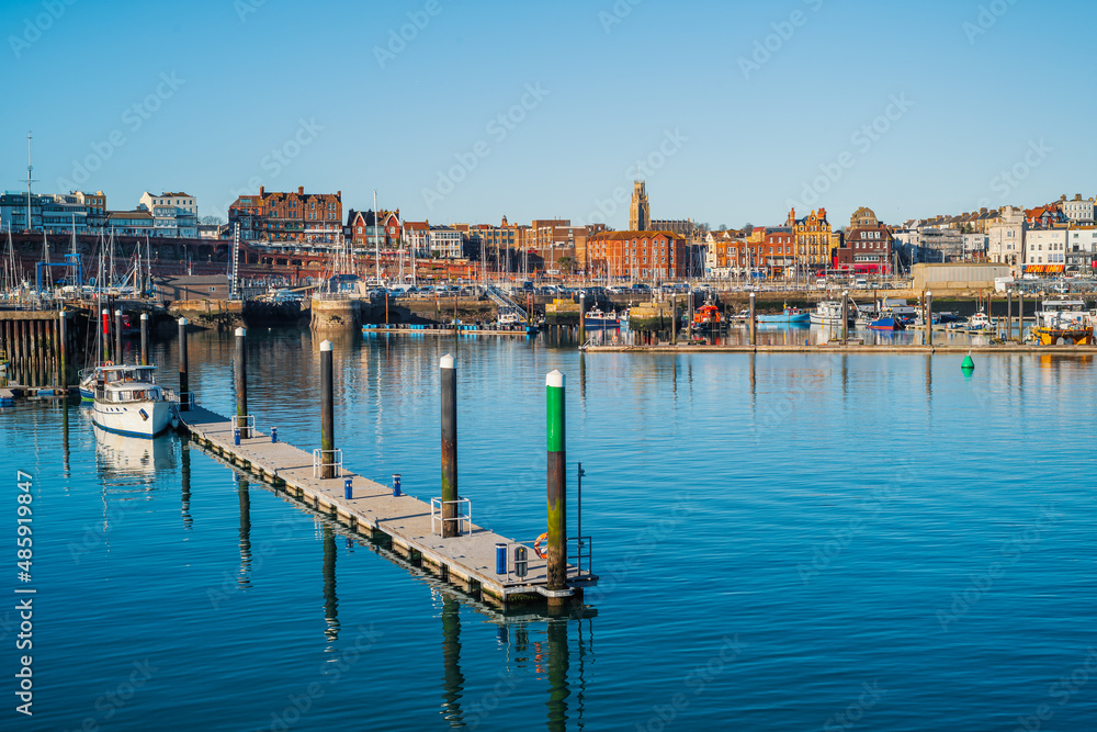 Jetty walkway and mornings in Ramsgate Royal Harbour. The impressive architecture of the harbour front buildings and town can be seen in the background.