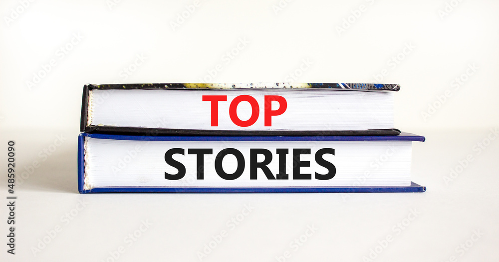 Top stories symbol. Concept words Top stories on books on a beautiful white table white background. Business story and top stories concept, copy space.