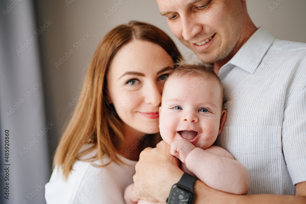 a happy family with a newborn baby. mom, dad and baby. a happy family with a newborn baby. mom, dad and baby.