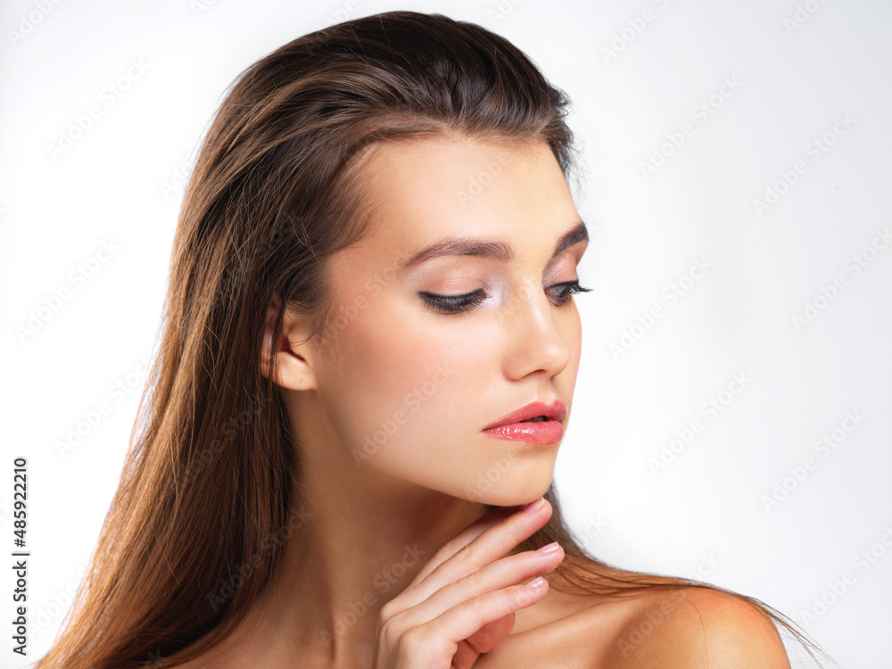 Flawlessly feminine. Studio shot of a beautiful young woman posing against a grey background. Flawlessly feminine. Studio shot of a beautiful young woman posing against a grey background.