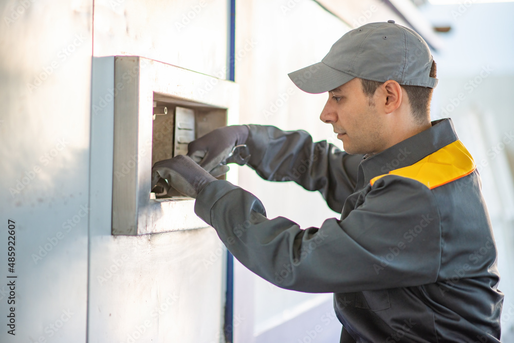 Worker fixing an industrial machinery