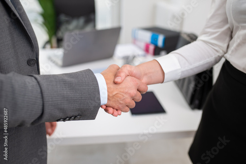 People shaking hands in an office