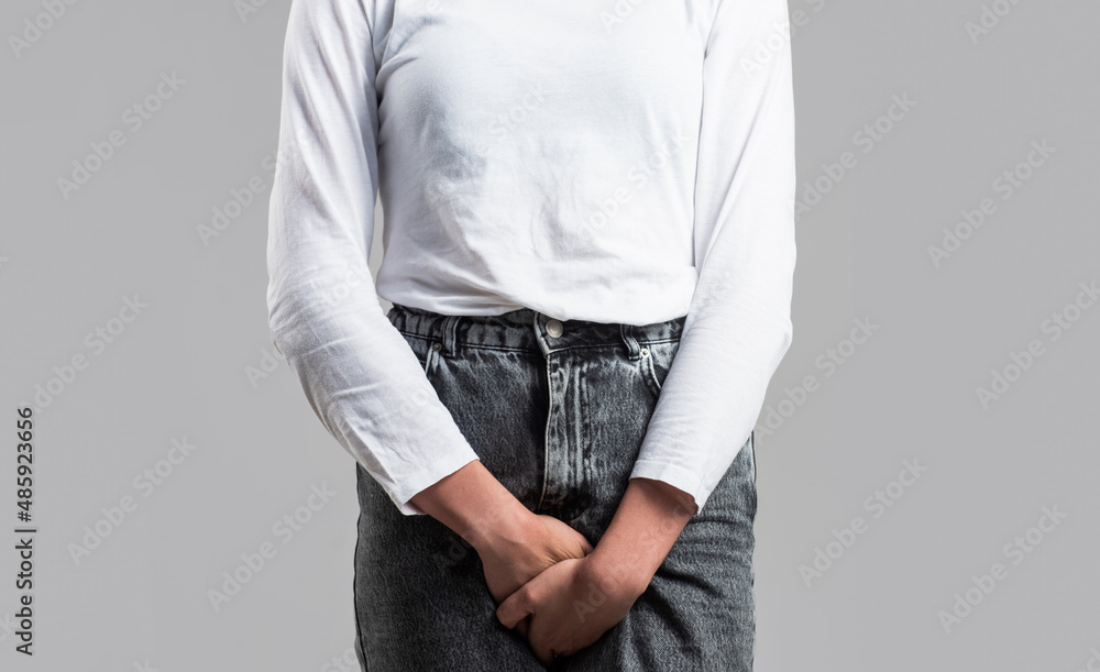 Fototapeta Sick woman hands holding pressing her crotch lower abdomen