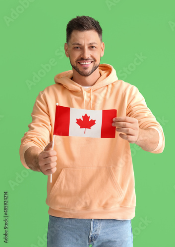 Happy young man with flag o...