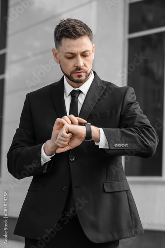 Stylish businessman using s...