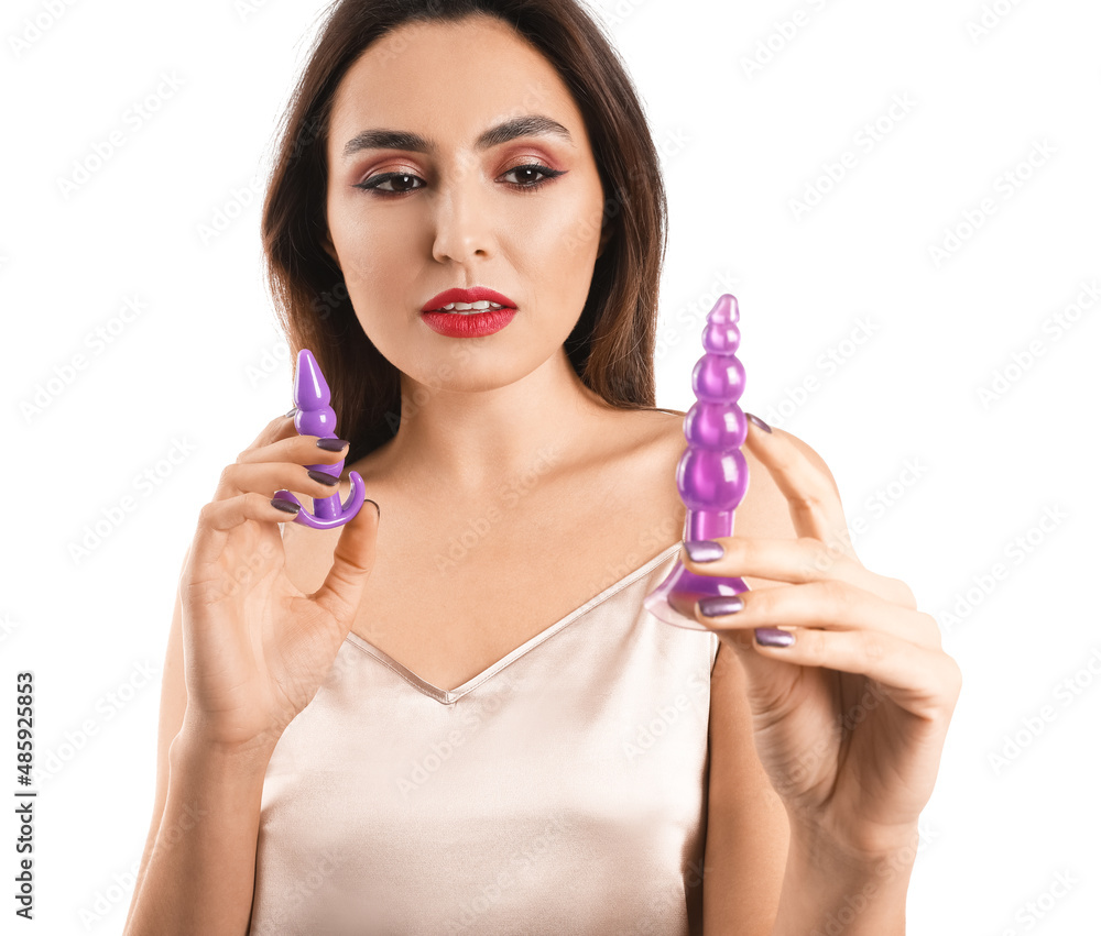 Young woman with butt plugs from sex shop on white background Young woman with butt plugs from sex shop on white background