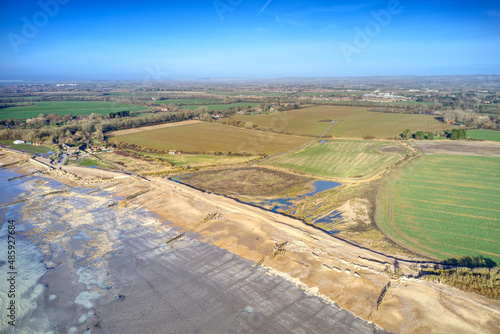 Aerial view of the damaged sea defences of Climping Beach, with the old broken concrete wall offering some protection to the new shingle bank. photo