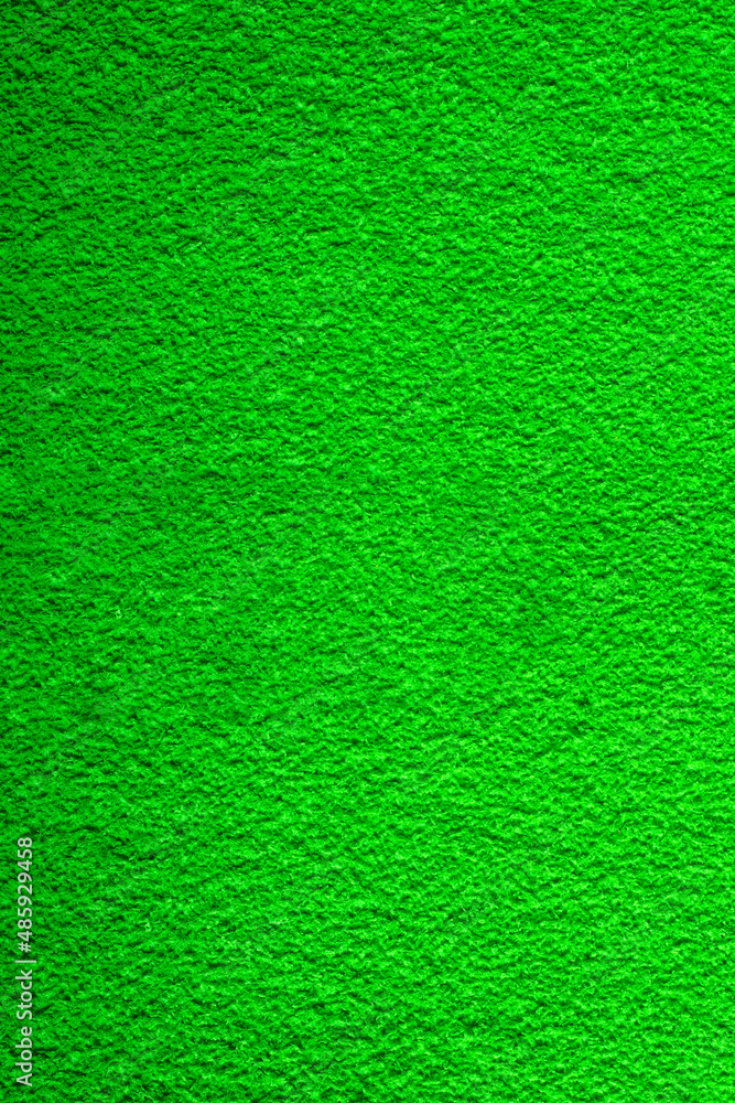 Fototapeta premium Fine-grained felt green fabric. artificial grass. fleecy textured background.