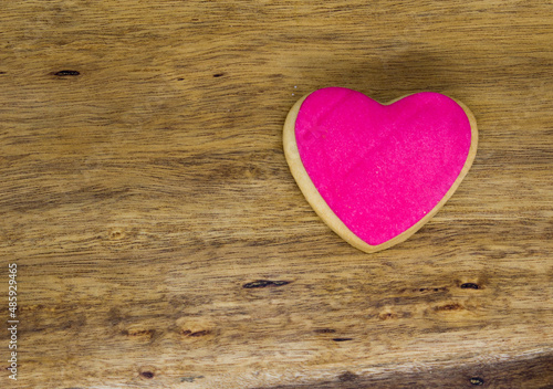 word love cast in homemade colored cookies on wooden table