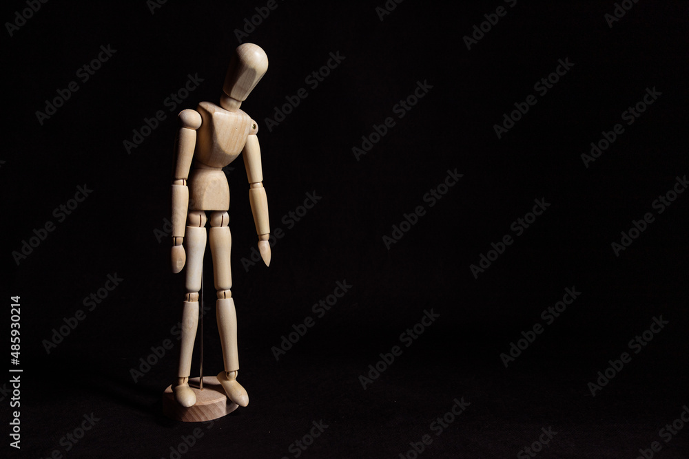 Sad wooden mannequin with his head lowered. Symbol of depression and breakdown Sad wooden mannequin with his head lowered. Symbol of depression and breakdown