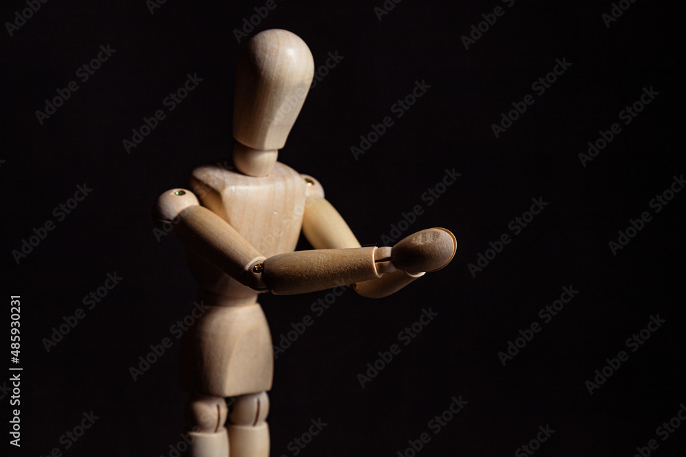 Wooden mannequin with folded hands. Symbol of prayer and religiosity Wooden mannequin with folded hands. Symbol of prayer and religiosity