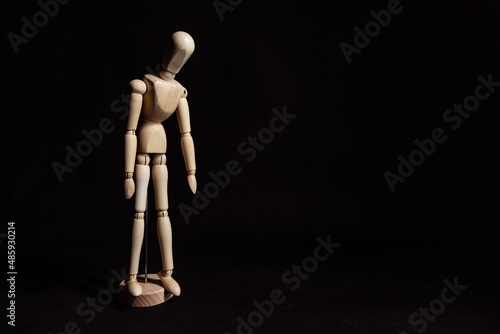 Sad wooden mannequin with his head lowered. Symbol of depression and breakdown