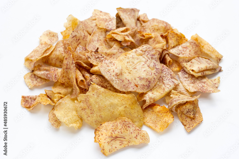 Crispy taro chips on white background. Crispy taro chips on white background.