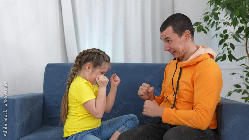 happy family teamwork. dad daughter clap their hands and hug rejoice. happy family business teamwork concept. dad daughter at home on the couch success clap their hands winner hug. family together happy family teamwork. dad daughter clap their hands and hug rejoice. happy family business teamwork concept. dad daughter at home on the couch success clap their hands winner hug. family together