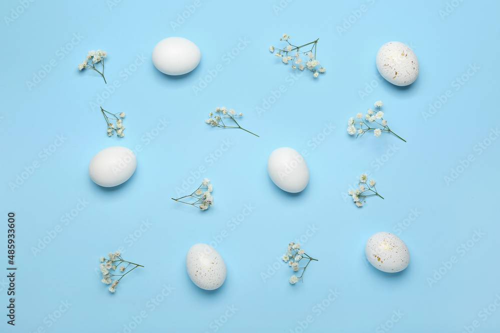 Composition with beautiful Easter eggs and gypsophila flowers on color background
