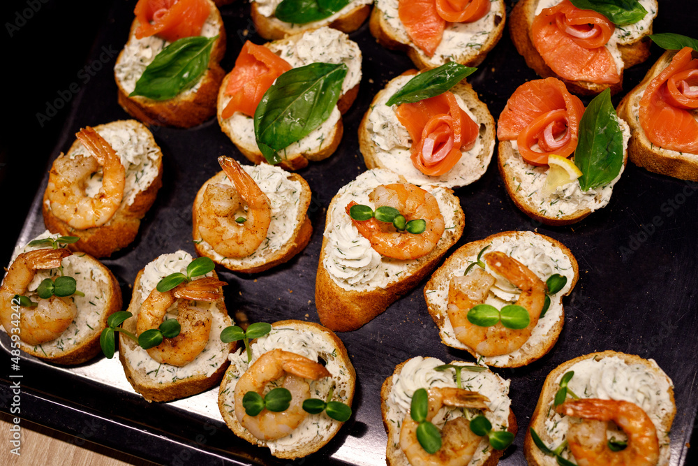 Top view of various Bruschettas with salmon and shrimps. Seafood sandwiches. Top view of various Bruschettas with salmon and shrimps. Seafood sandwiches.