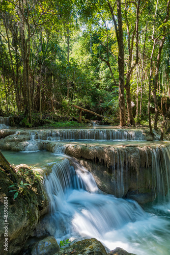 Erawan National Park in Thailand. Erawan Waterfall is a popular tourist destination and famous for its emerald blue water. Deep forest in tropical climate with fantasy atmosphere. 