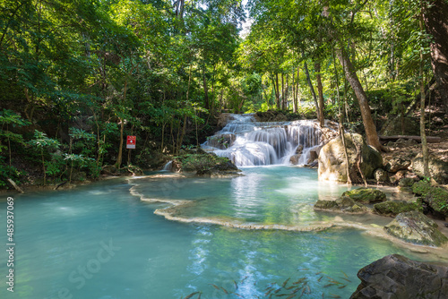 Erawan National Park in Thailand. Erawan Waterfall is a popular tourist destination and famous for its emerald blue water. Deep forest in tropical climate with fantasy atmosphere.  