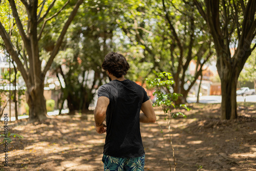 Young guy running and jogging at a park outdoors. Athlete male person during workout. High quality photo