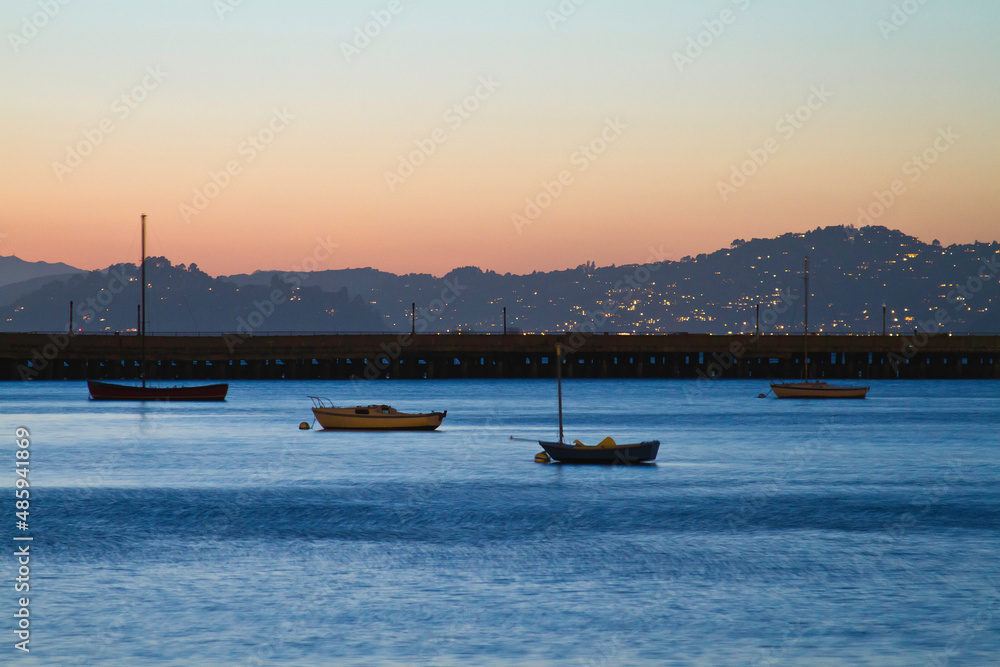 boats in the harbor at sunset