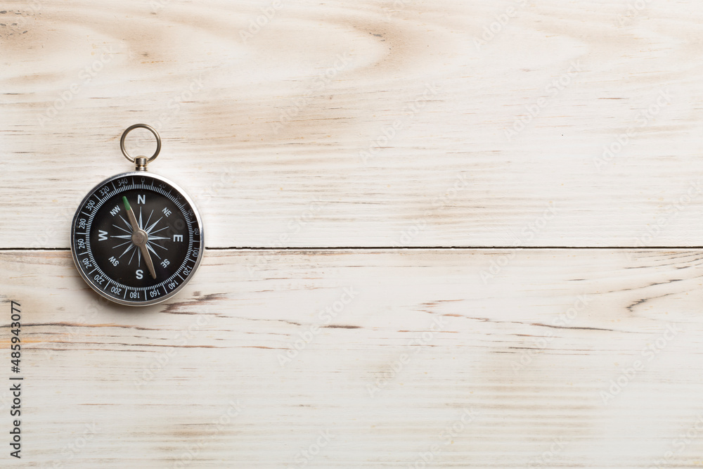 Old compass on wooden background Old compass on wooden background