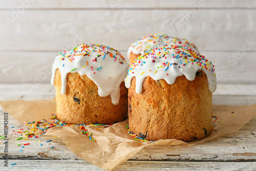 Delicious Easter cakes on white wooden background photo