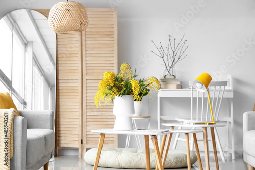 Vase with mimosa flowers on...