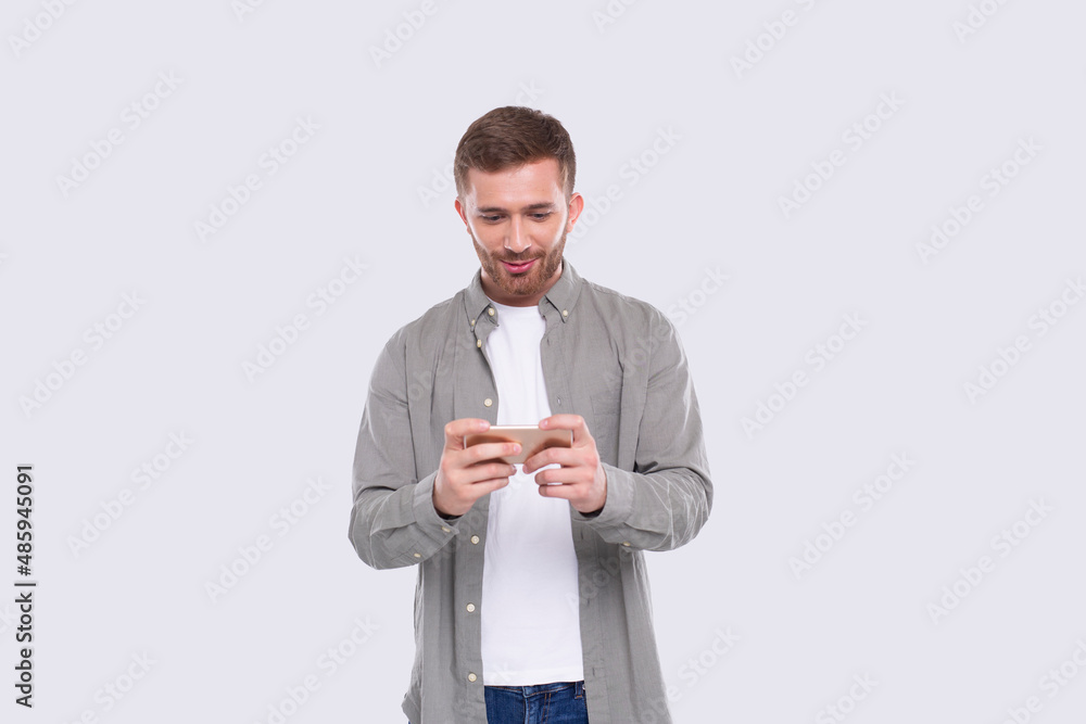 Man Playing Phone Games. Man Excited Playing Mobile games. Gamer Isolated Man Playing Phone Games. Man Excited Playing Mobile games. Gamer Isolated